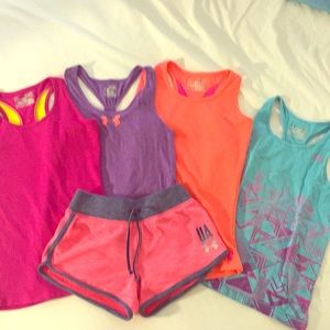 Set of girls Underarmour shorts are and tag tops.